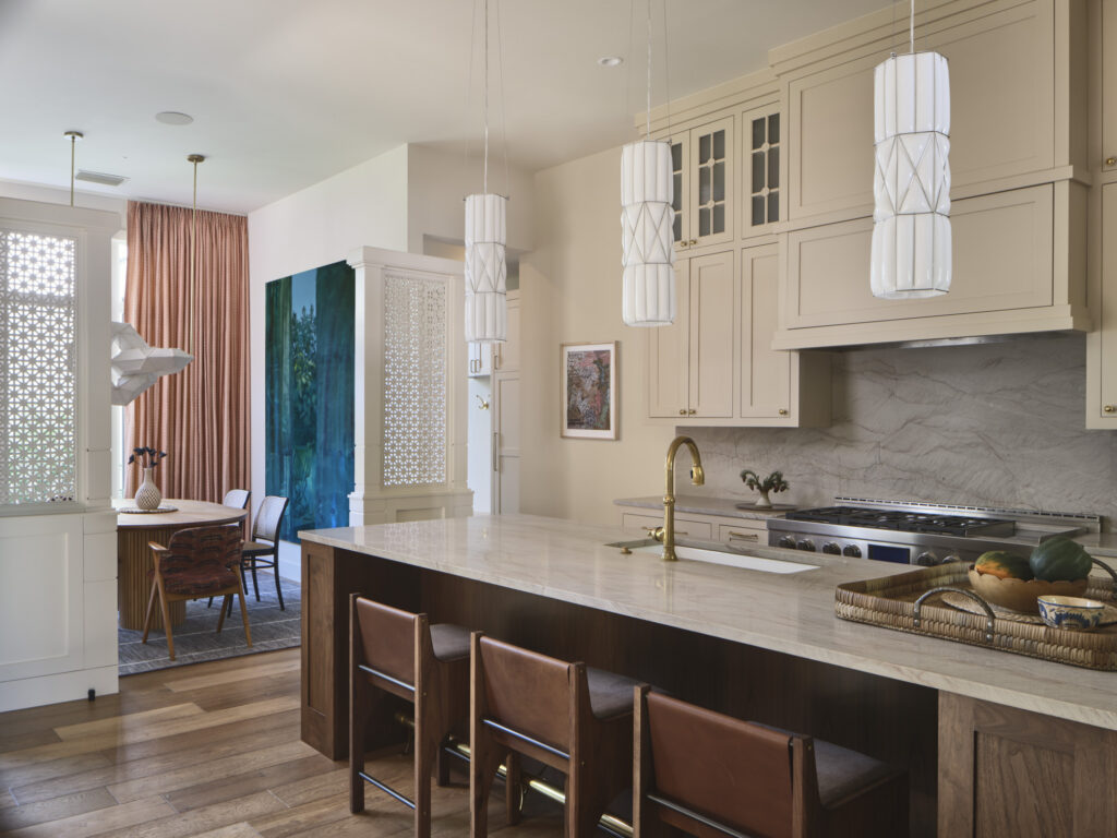 Elegant kitchen with marble countertops, brass fixtures, and open layout designed by Amity Worrel & Co. — aging-in-place kitchen design in Austin, TX