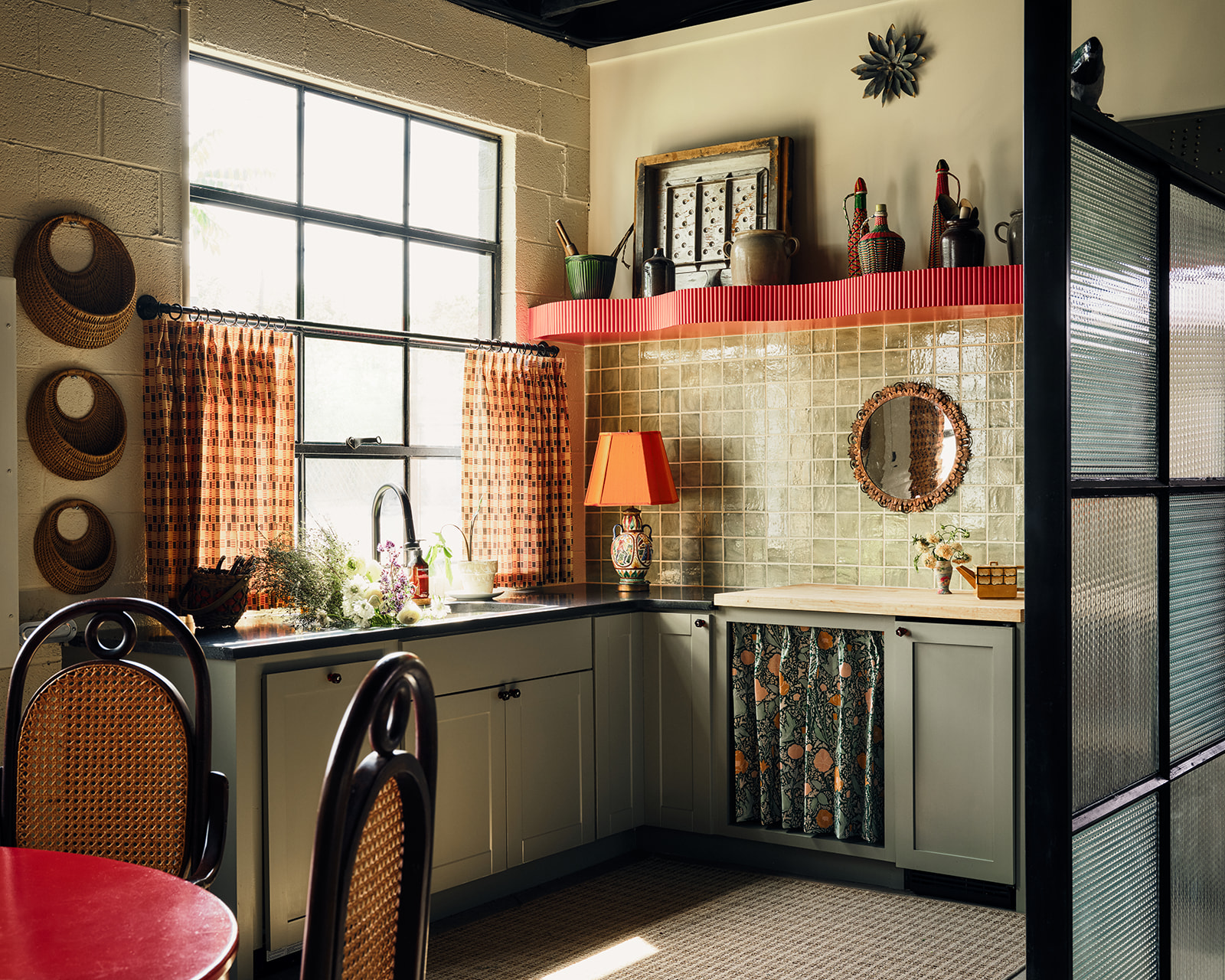 Character-rich kitchen with open lower shelving, tile backsplash, and abundant natural light designed by Amity Worrel & Co. — accessible kitchen design for aging in place in Austin, TX