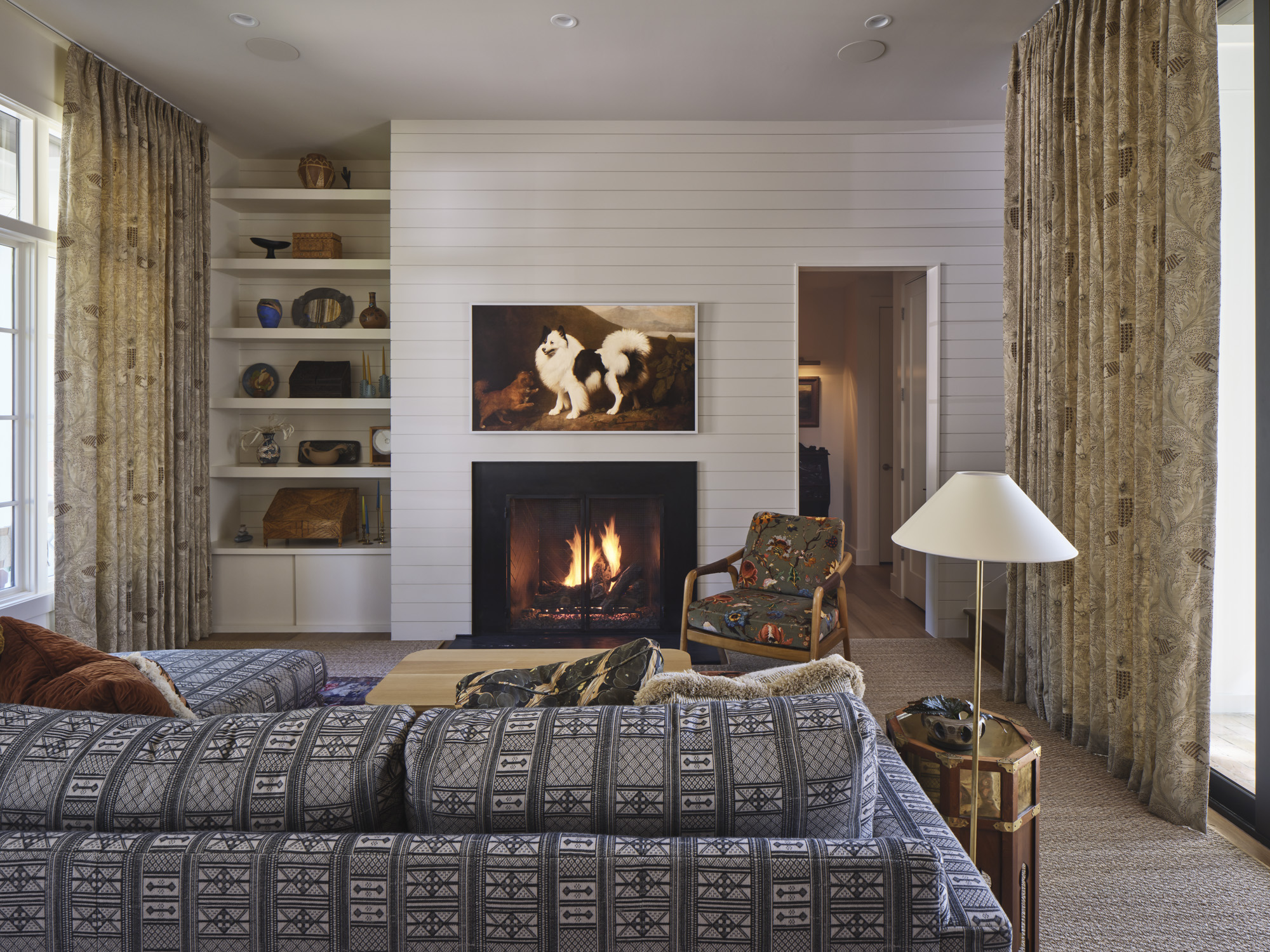 Warm living room with shiplap fireplace wall, built-in shelving, and layered textiles designed by Amity Worrel & Co. — aging-in-place interior design in Austin, TX