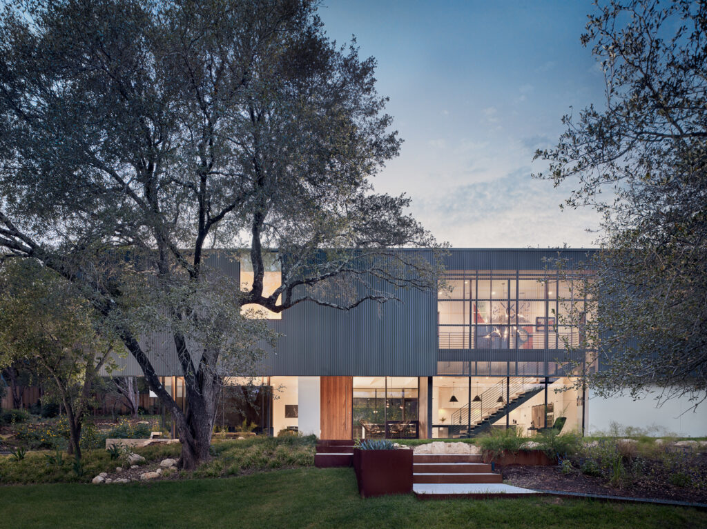 Modern two-story Austin home with steel and glass facade built by Texas Construction Company — residential remodeling and aging-in-place specialist