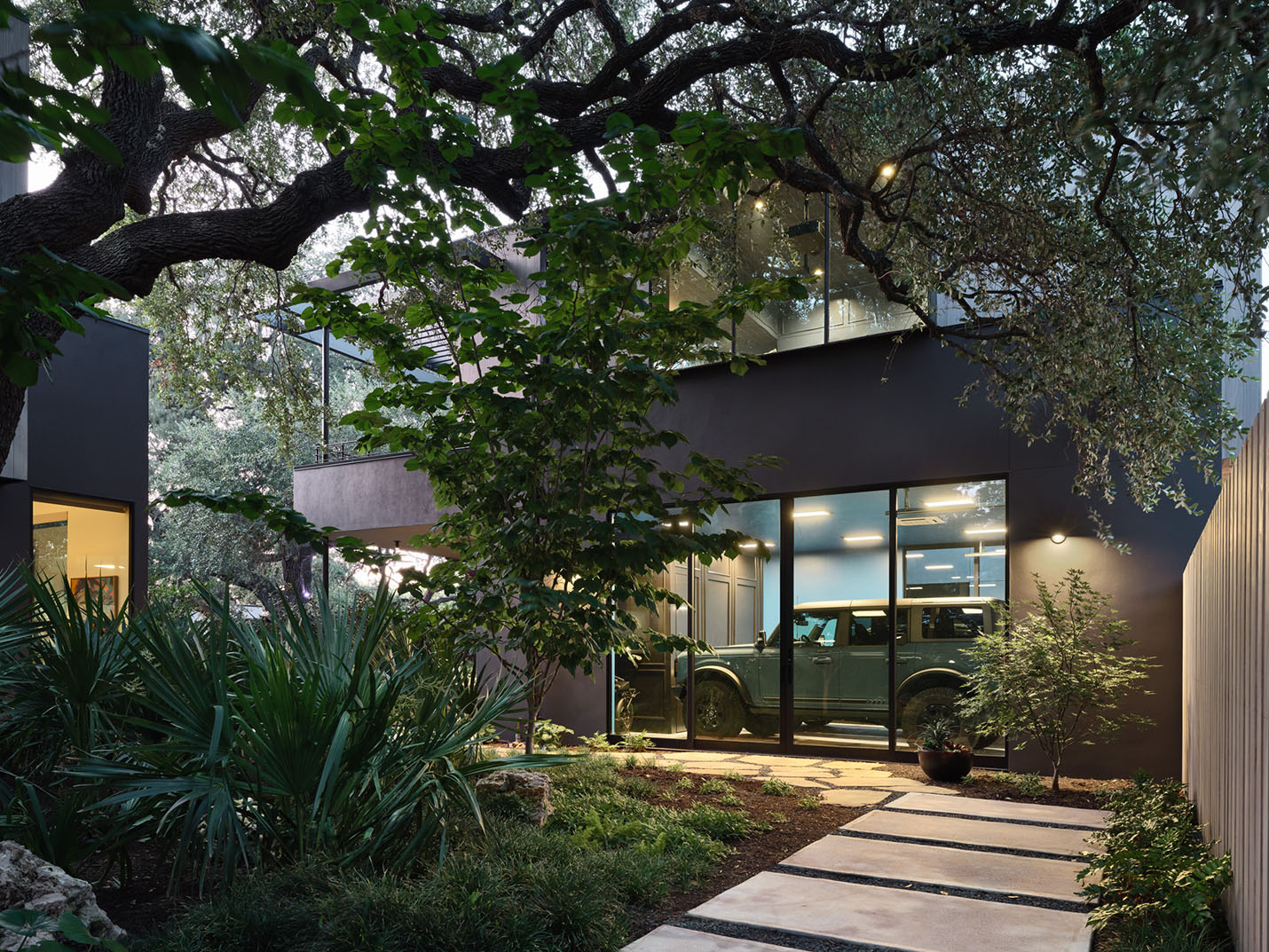 Illuminated exterior pathway and accessible entryway of an Austin home by Texas Construction Company — aging-in-place exterior access and remodeling in Austin, TX