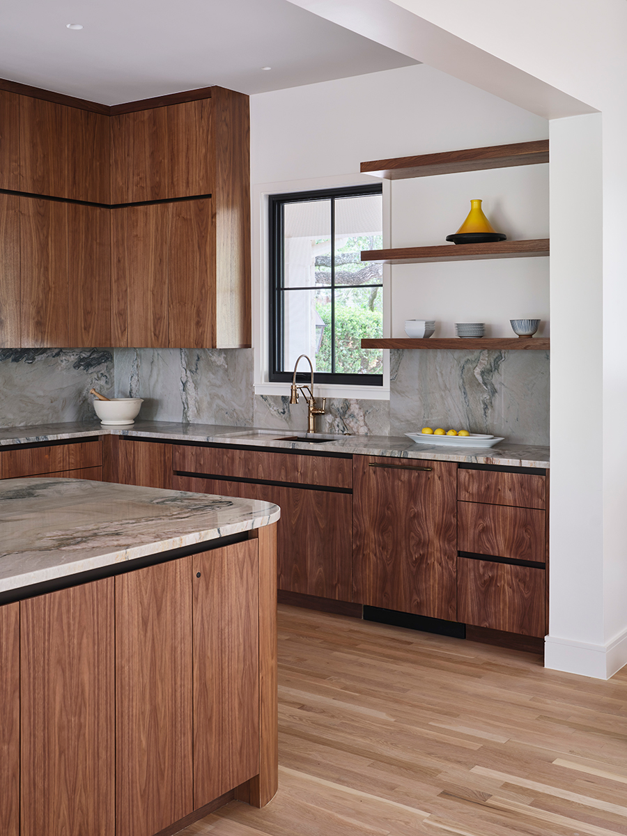 Beautifully remodeled kitchen with walnut cabinetry and marble countertops by Texas Construction Company — aging-in-place kitchen remodeling in Austin, TX